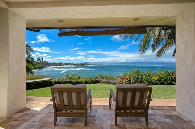 view of patio / terrace with a water view and ceiling fan