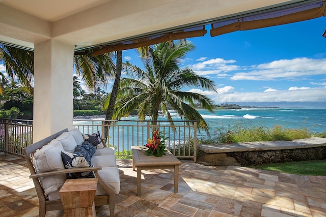 view of patio / terrace with a water view and a balcony