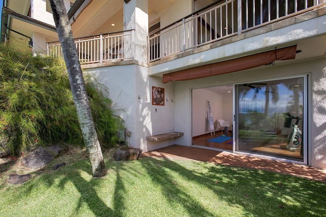 exterior space featuring a yard and stucco siding