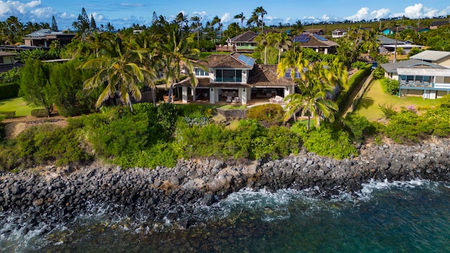 rear view of property with a water view