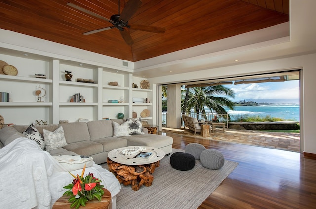 living area featuring built in features, a raised ceiling, wooden ceiling, dark wood-type flooring, and vaulted ceiling