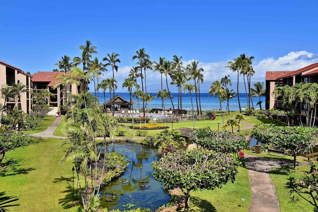 view of home's community with a water view, a yard, and a gazebo