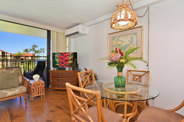 dining area with a notable chandelier, dark wood-type flooring, a wall mounted air conditioner, and a textured ceiling