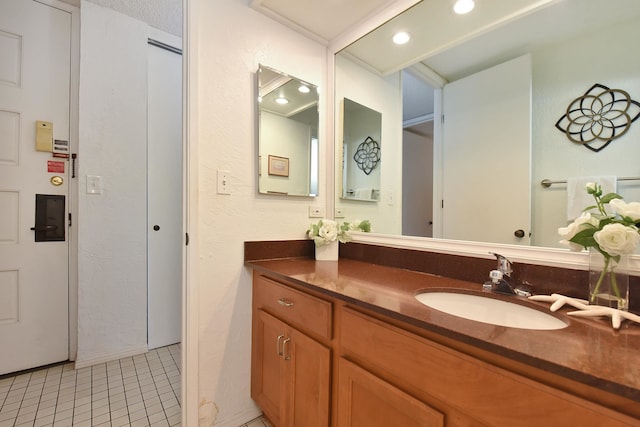 bathroom featuring tile floors and vanity