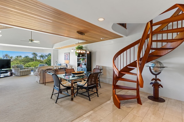 carpeted dining area featuring wood ceiling and ceiling fan with notable chandelier