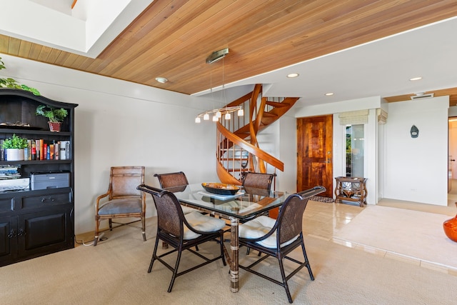 carpeted dining room featuring wooden ceiling and a skylight