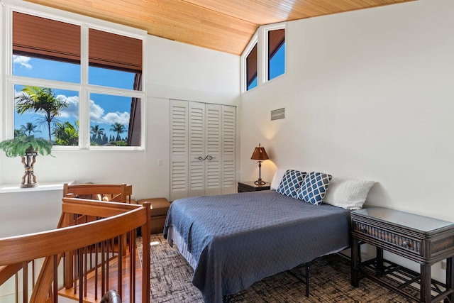 bedroom featuring a closet, hardwood / wood-style flooring, and wooden ceiling