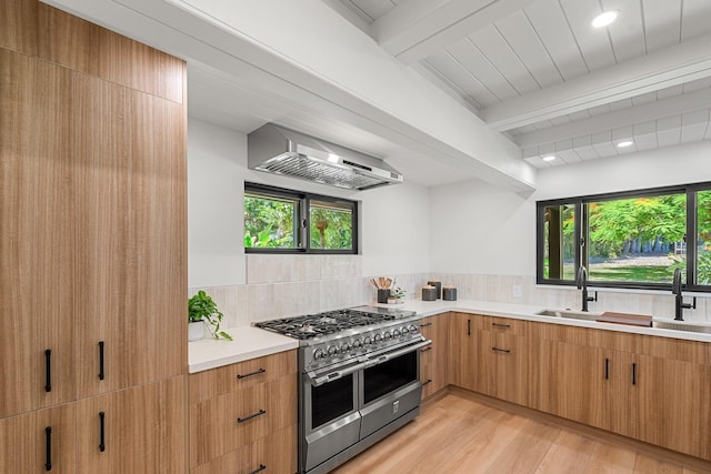 965 Hog Back Rd Unit 1, Haiku, HI 96708 - kitchen with double oven range, wall chimney exhaust hood, beamed ceiling, backsplash, and light countertops