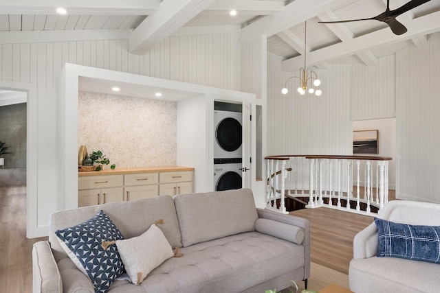 965 Hog Back Rd Unit 1, Haiku, HI 96708 - living area featuring stacked washer and clothes dryer, wood finished floors, a ceiling fan, and a chandelier