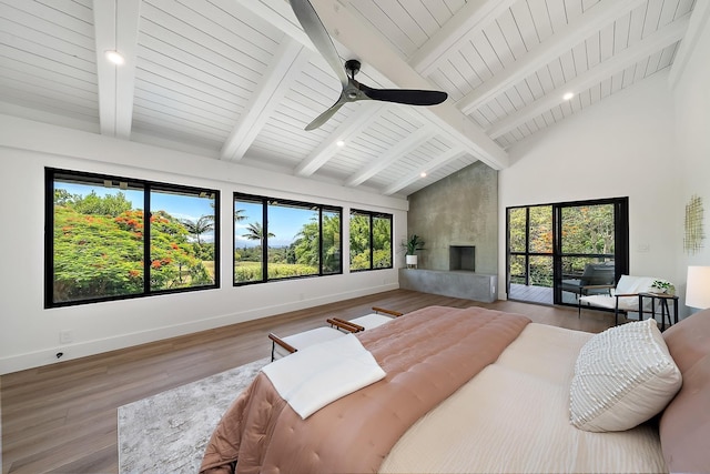 965 Hog Back Rd Unit 1, Haiku, HI 96708 - bedroom with high vaulted ceiling, multiple windows, a large fireplace, wood finished floors, and ceiling fan