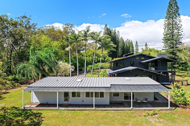 965 Hog Back Rd Unit 1, Haiku, HI 96708 - rear view of house with a yard, a patio, a metal roof, and a standing seam roof