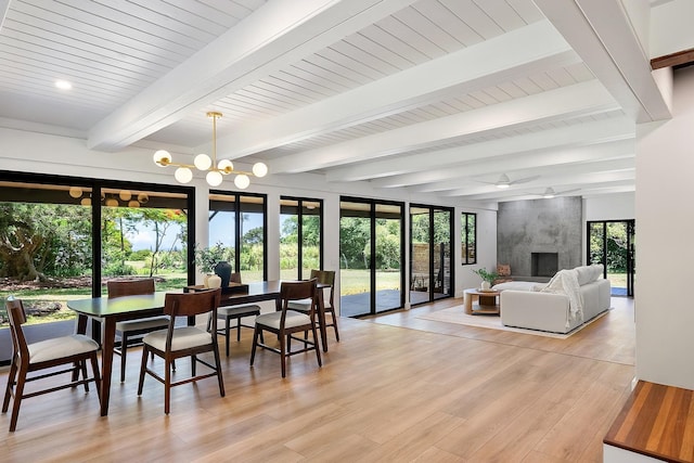965 Hog Back Rd Unit 1, Haiku, HI 96708 - dining area featuring light wood finished floors, a high end fireplace, ceiling fan, a chandelier, and beam ceiling