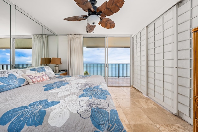 bedroom featuring ceiling fan, access to exterior, and multiple windows