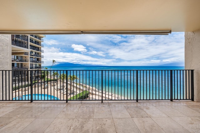 balcony featuring a water view and a view of the beach