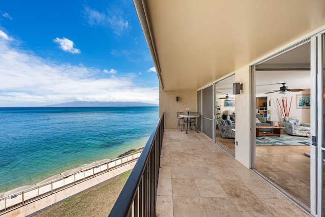 balcony with a water view and a beach view