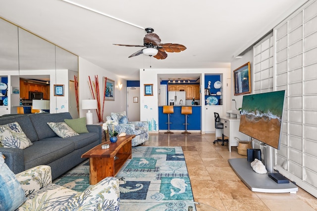 tiled living room with ceiling fan