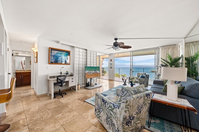 living room with ceiling fan and expansive windows