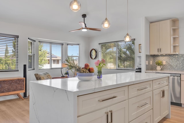 kitchen featuring light stone counters, decorative light fixtures, open shelves, tasteful backsplash, and light wood-style flooring