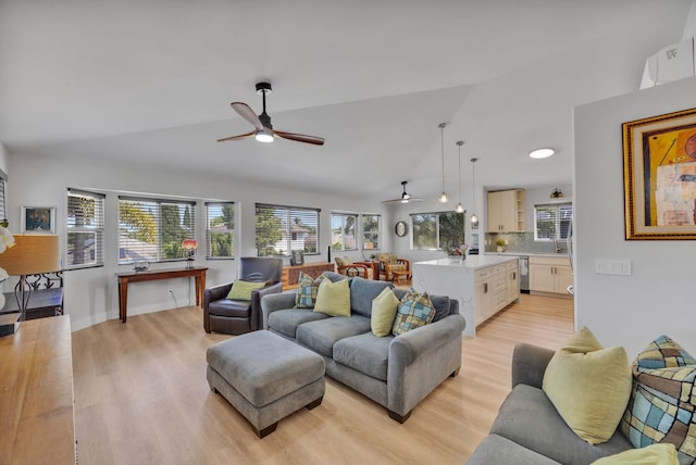 living room featuring lofted ceiling, ceiling fan, light wood-type flooring, and baseboards