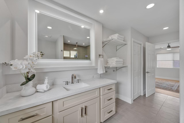 bathroom featuring baseboards, recessed lighting, vanity, and tile patterned floors