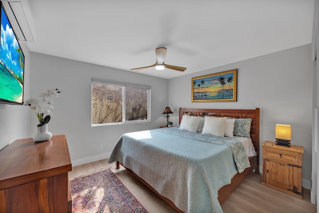 bedroom featuring baseboards, ceiling fan, and light wood finished floors