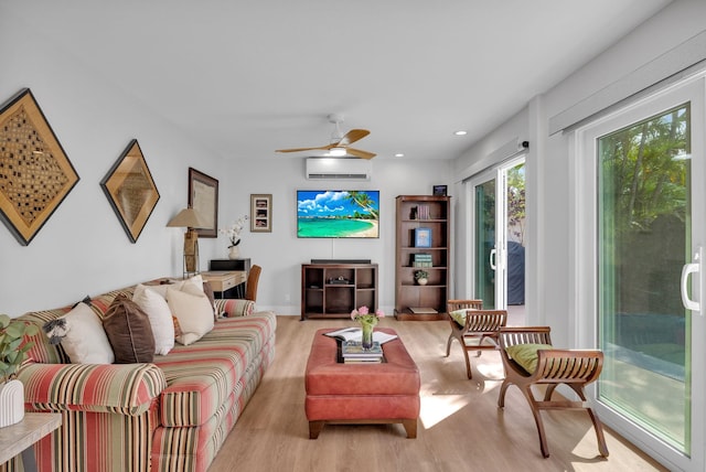 living area featuring ceiling fan, light wood-type flooring, a wall mounted air conditioner, and recessed lighting