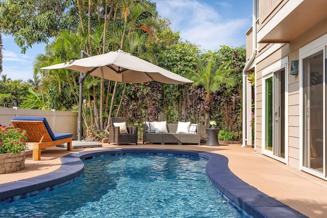 view of swimming pool featuring a patio area, fence, and a fenced in pool