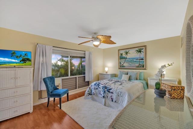 bedroom with ceiling fan and wood-type flooring