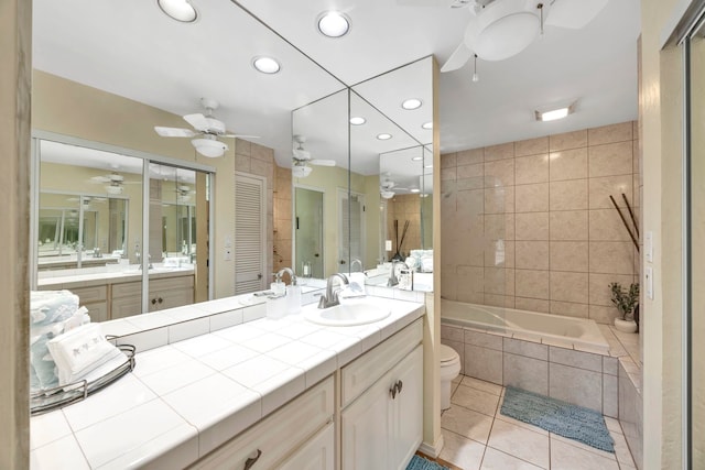 full bathroom featuring separate shower and tub, vanity, tile patterned floors, and toilet