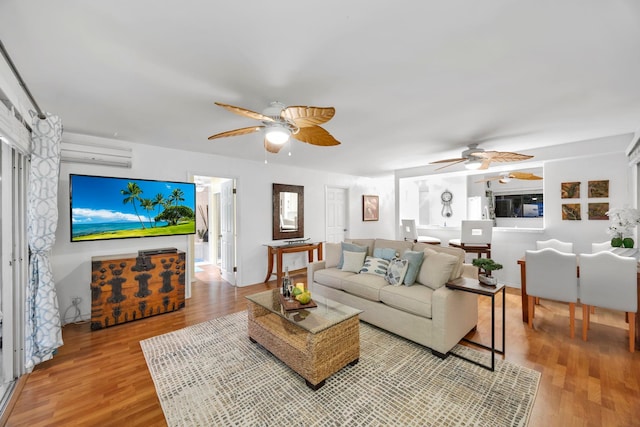 living room with a wall mounted AC and hardwood / wood-style floors