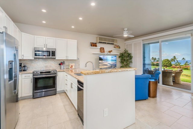3950 Kalai Waa St Unit R 103, Kihei, HI 96753 - kitchen with stainless steel appliances, a peninsula, decorative backsplash, recessed lighting, and a ceiling fan