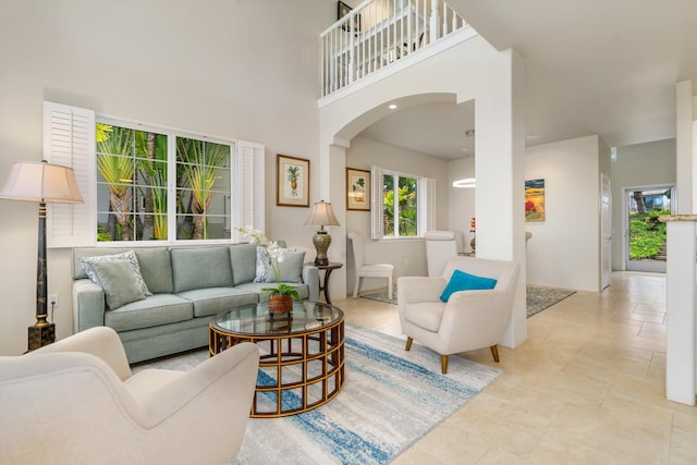 3950 Kalai Waa St Unit R 103, Kihei, HI 96753 - living area featuring a towering ceiling, arched walkways, and light tile patterned flooring