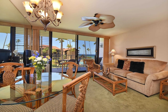 carpeted living room with ceiling fan with notable chandelier