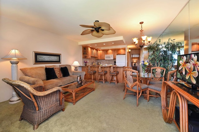 carpeted living room featuring ceiling fan with notable chandelier