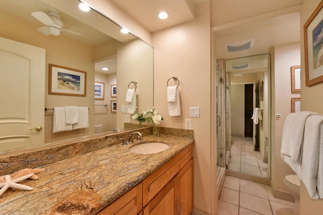 bathroom featuring tile flooring, ceiling fan, vanity, and toilet