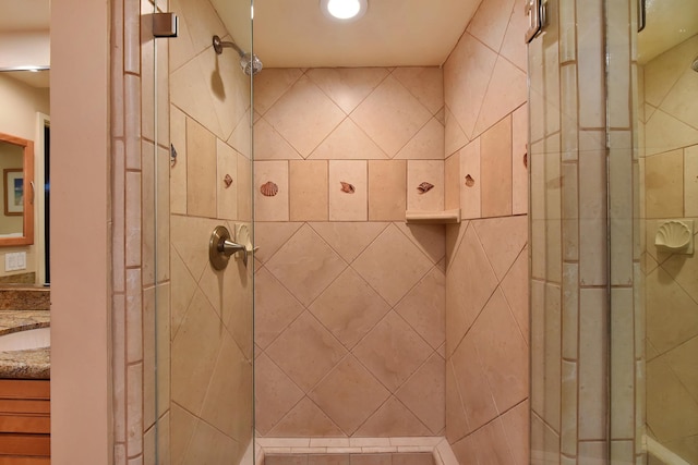 bathroom with vanity and a shower with door