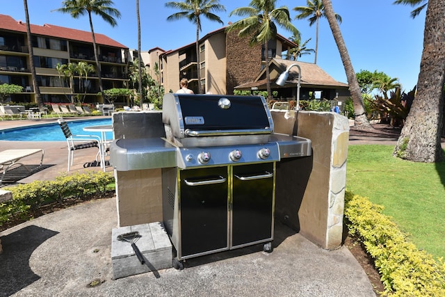 view of terrace with a grill and a community pool