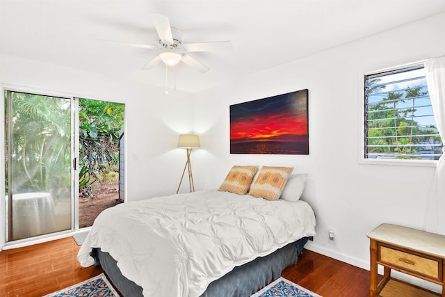 bedroom featuring dark hardwood / wood-style flooring, access to outside, and ceiling fan