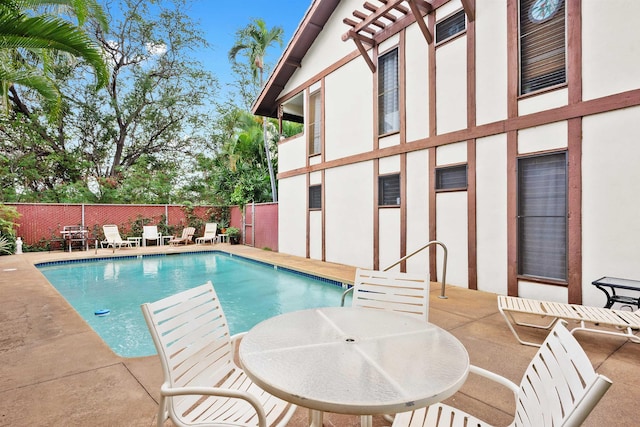 view of swimming pool with a patio