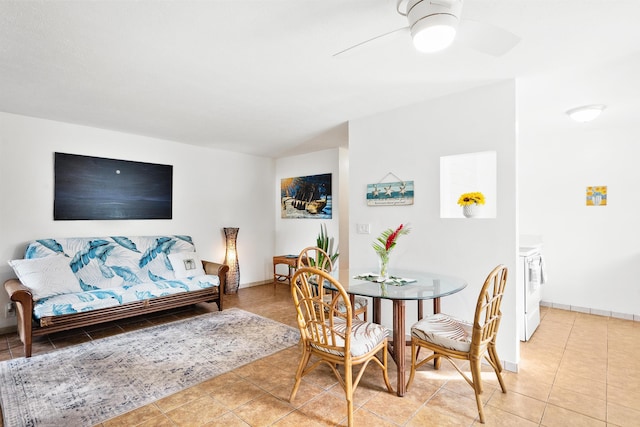 dining space with light tile patterned floors, washer and clothes dryer, and ceiling fan