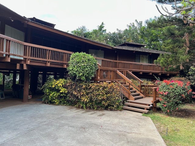 back of house with a patio area and a wooden deck