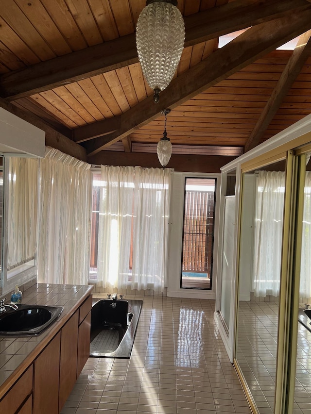 interior space with vaulted ceiling with beams, wood ceiling, and a wealth of natural light