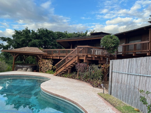 view of pool featuring a hot tub and a wooden deck