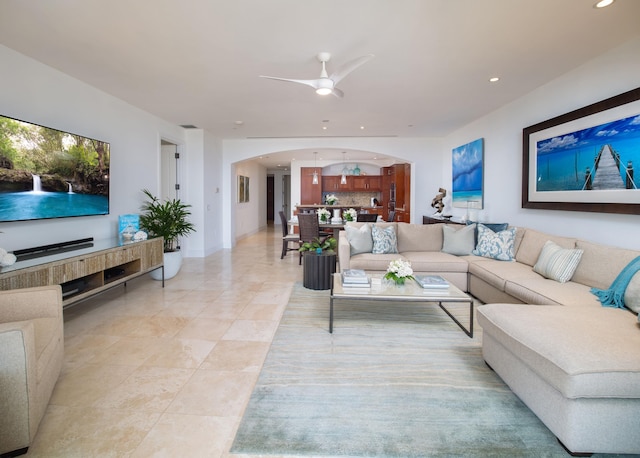 tiled living room with ceiling fan