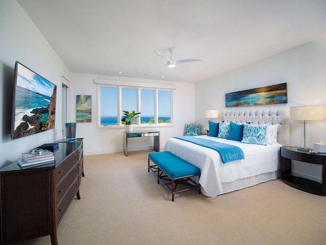 bedroom with ceiling fan and light carpet