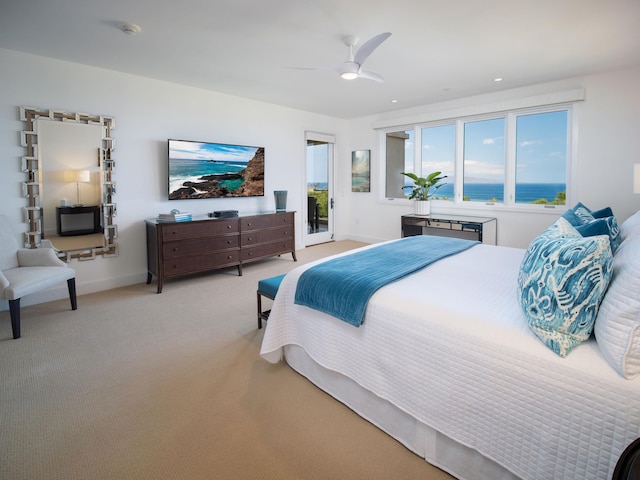 bedroom with access to exterior, ceiling fan, and light colored carpet