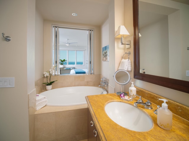 bathroom with vanity and tiled bath