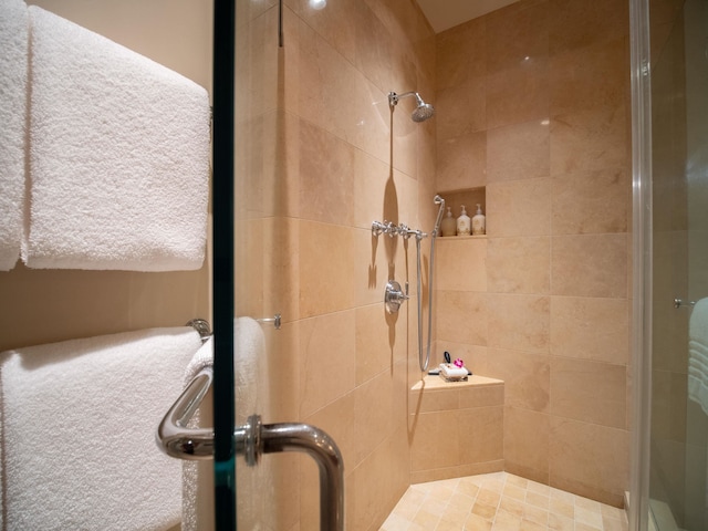 bathroom with a shower with door