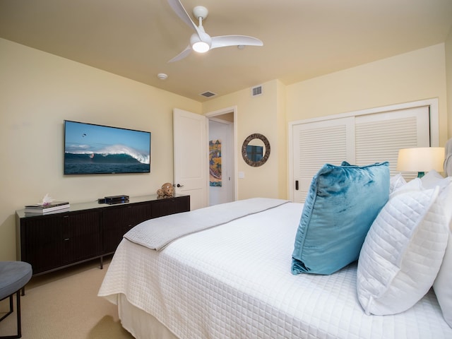 bedroom with ceiling fan and light colored carpet