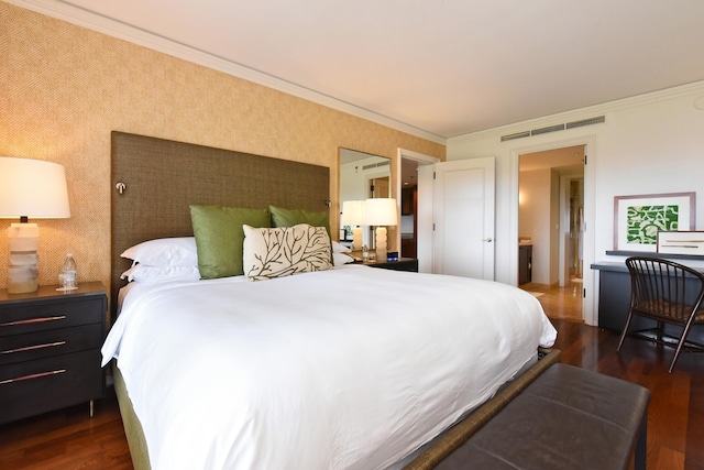 bedroom with ornamental molding and dark wood-type flooring